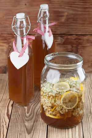 Making elderberry syrup with lemons and cane sugar, alternative medicine for cough, cold or flu の写真素材