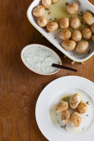Roasted baby potatoes with thyme, olive oil and salt with tzatzikiの写真素材