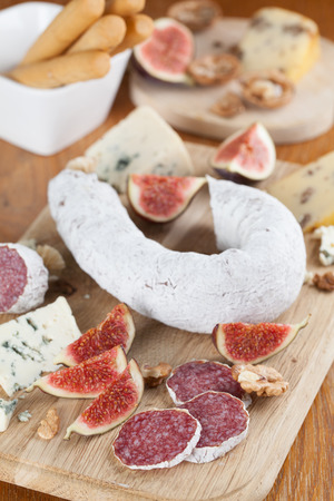 Meat with cheese, figs, nuts and grissiniの写真素材