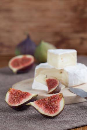 Camembert and fresh figs on a cutting boardの写真素材