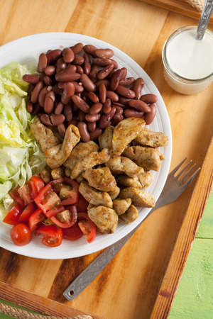 Turkey salad with fresh iceberg lettuce, cherry tomatoes and red beansの写真素材