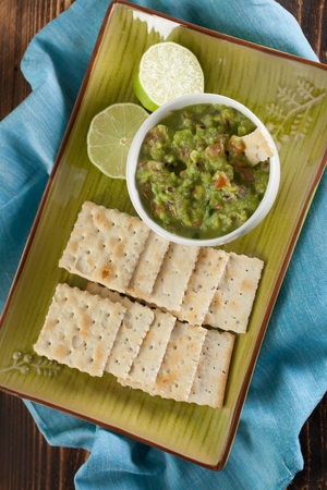 Bowl with freshly made guacamole and crackers. Shallow dofの写真素材