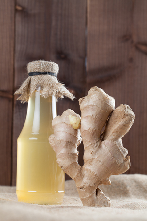 Ginger root and bottle with ginger syrup. Shallow dofの写真素材