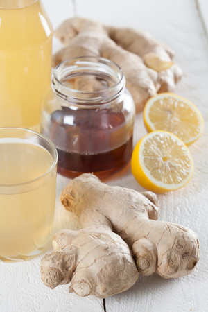 Ginger drink and the ingredients. Ginger, honey, lemon and syrup.の写真素材