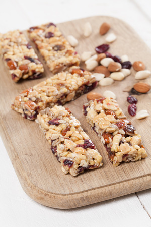 Granola bars with various nuts, seeds and cranberriesの写真素材