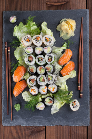 Sushi set on a slate board. Maki, uramaki and nigiri sushi.の写真素材