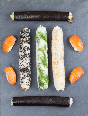 Homemade sushi rolls on a slate boardの写真素材