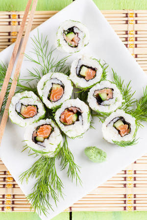 Uramaki sushi with cucumber, raw salmon and dill. Shallow dofの写真素材