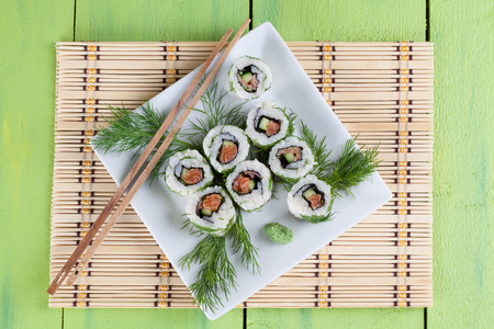 Uramaki sushi with cucumber, raw salmon and dill. Shallow dofの写真素材