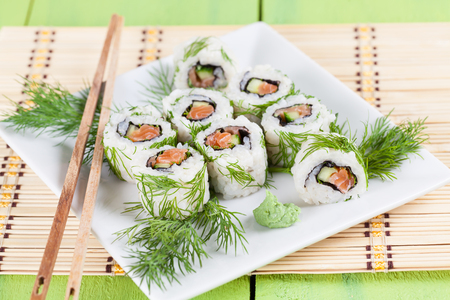 Uramaki sushi with cucumber, raw salmon and dill. Shallow dofの写真素材