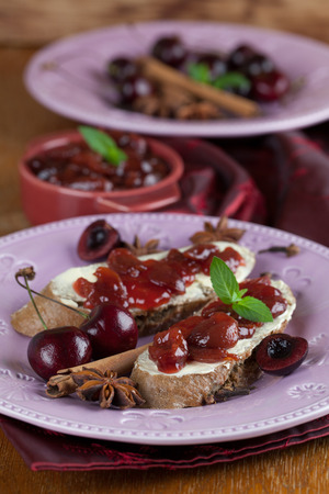 Bread with homemade spicy cherry jam. Shallow dofの写真素材
