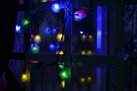 Multicolor Lights near to a window at night