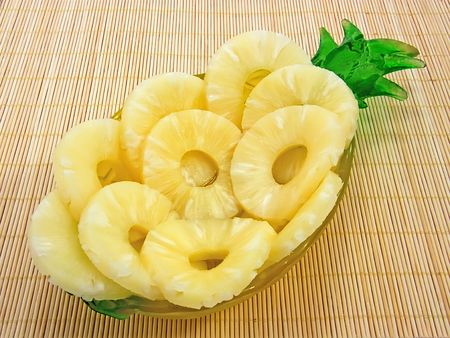 Pineapple rings on a platter forms pineapple