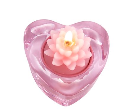 Aroma candle lotus flower in a glass candlestick in the form of hearts, close-up on a white background の写真素材
