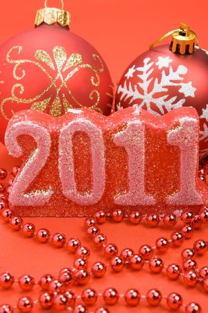 Christmas red balls, candle New Year 2011 and beads decorations close-up の写真素材