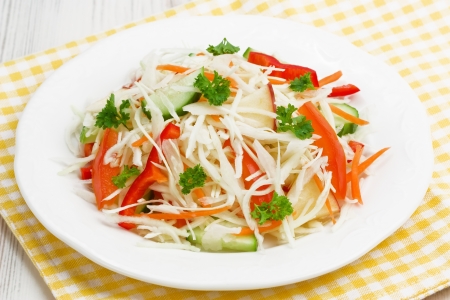 Cabbage spring salad with tomato, cucumber, red pepper,  apple and carrotの写真素材