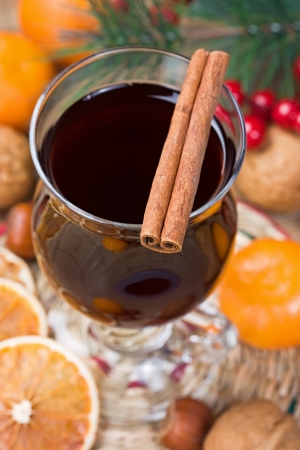 Mulled wine winter hot drink with cinnamon, dried orange slices, tangerine and walnutの写真素材