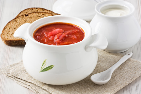 Beetroot soup red borscht with sour cream in white bowlの写真素材
