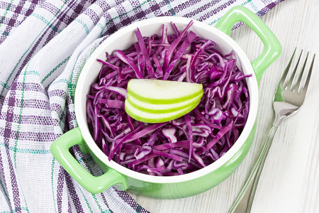 Delicious fresh healthy red cabbage salad with apple in bowlの写真素材