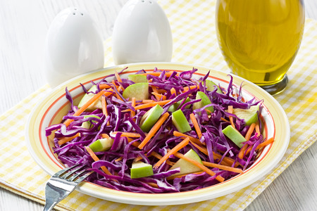 Delicious fresh red cabbage salad with carrot and green appleの写真素材