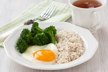 Healthy breakfast with egg, brown rice and broccoliの写真素材