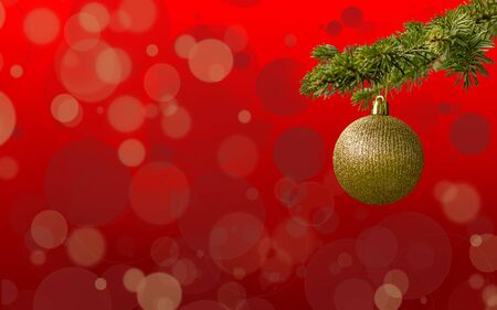 Fir tree branch with a golden glitter ball on red background. Bokeh effects. Christmastime. Christmas postcard.の写真素材