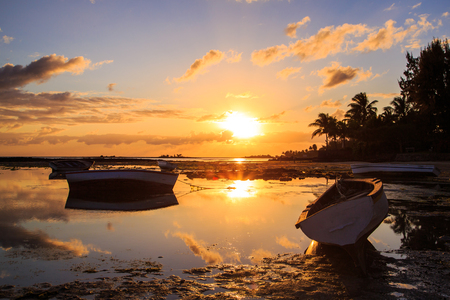 Boats docked during beautiful sunset  sunrise by the coasts of the islandの写真素材