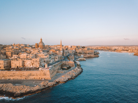 Amazing aerial panorama of the Valletta city, Malta. Flying over ancient town with huge defence walls and old port.の写真素材