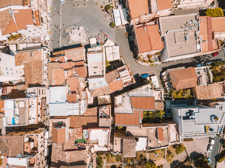 Aerial view of the Duomo in most popular Sicilian resort Taormina. Townscape of Taormina with cathedral, square and the hill with other buildings.