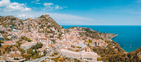 Aerial view of the Duomo in most popular Sicilian resort Taormina. Townscape of Taormina with cathedral, square and the hill with other buildings.の写真素材