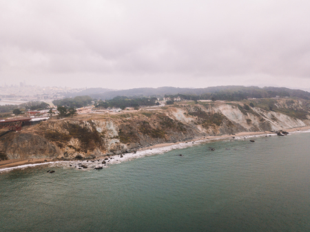 Aerial view of the Golden Gate bridge in San Francisco covered in clouds. Magical and spooky weather over California.の写真素材
