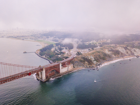 Aerial view of the Golden Gate bridge in San Francisco covered in clouds. Magical and spooky weather...