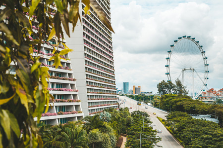 SINGAPORE - MAY 08, 2017: Marina Bay Sands hotel view from the Gardens bay. Marina Bay Sands is an integrated resort fronting Marina Bay in Singapore with amazing nature and ferris wheel around it.のeditorial素材