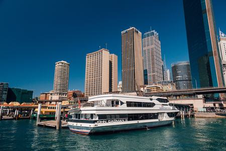 Darling Harbour district area with people on the promenade, boats near the docs and city skyline view. Sydney, Australia. August 30, 2017.のeditorial素材