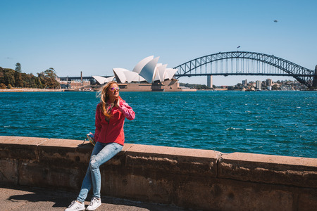 Young girl walking in the park in Sydney by the Opera house and Harbour bridge. Sydney. Australia. August 30, 2017.のeditorial素材