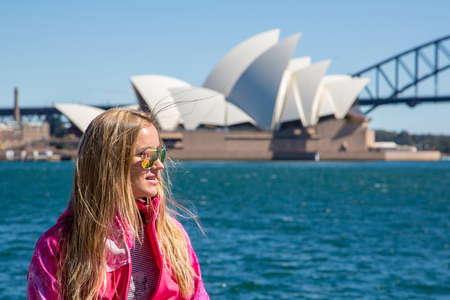 Young girl walking in the park in Sydney by the Opera house and Harbour bridge. Sydney. Australia. August 30, 2017.のeditorial素材
