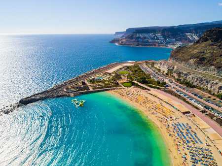 Beautiful aerial view of Playa de Amadores bay with other cliffs on the sea shore on the Gran Canaria island in Spain. Gorgeous sea shore of the island.の写真素材