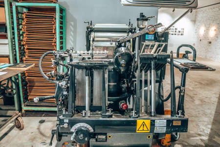 Old typography printing machine with letter samples. Mechanical printing process.
