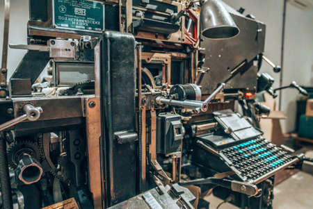 Old typography printing machine with letter samples. Mechanical printing process.