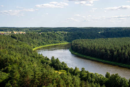 Summer landscape on the banks of the green river at duskの写真素材