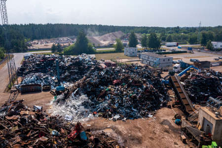 Old damaged cars on the junkyard waiting for recyclingの写真素材