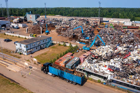 Old damaged cars on the junkyard waiting for recycling