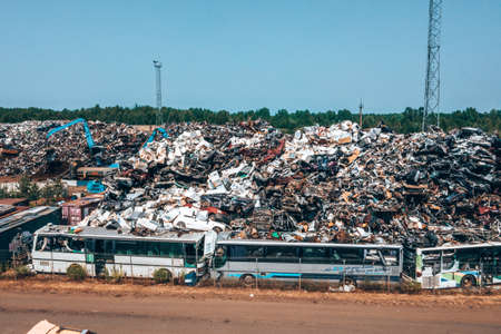 Old damaged cars on the junkyard waiting for recyclingのeditorial素材