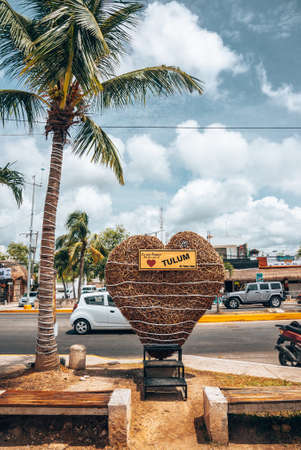 Tied up heart shape made up of straw with tulum sign at roadsideのeditorial素材