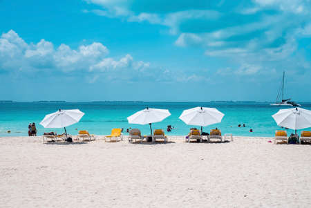 Deckchairs under canopy shade for resting on beach sand during summerのeditorial素材