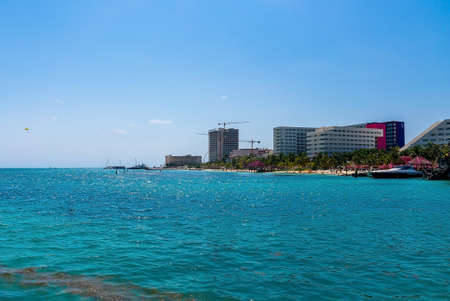 Scenic view of sea by hotel and under construction buildings against skyのeditorial素材