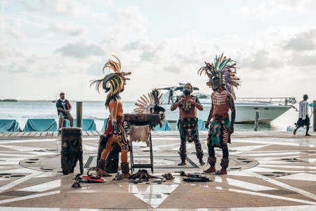 Folklore artists in creepy costumes performing against seaのeditorial素材