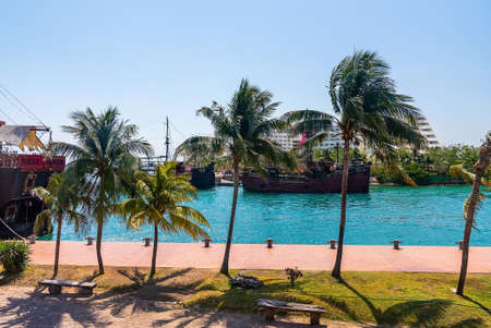 Pirate ships sailing on sea with hotel building against skyのeditorial素材