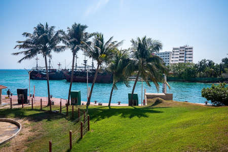Pirate ships sailing on sea with hotel building against skyのeditorial素材