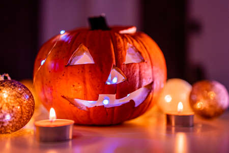 Spooky smiling halloween pumpkin in burning fire candles flames.の写真素材